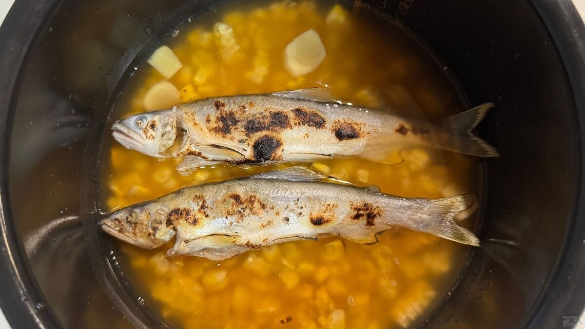 炊飯器に焼いたアユと焼きトウモロコシ、生姜を入れたところ